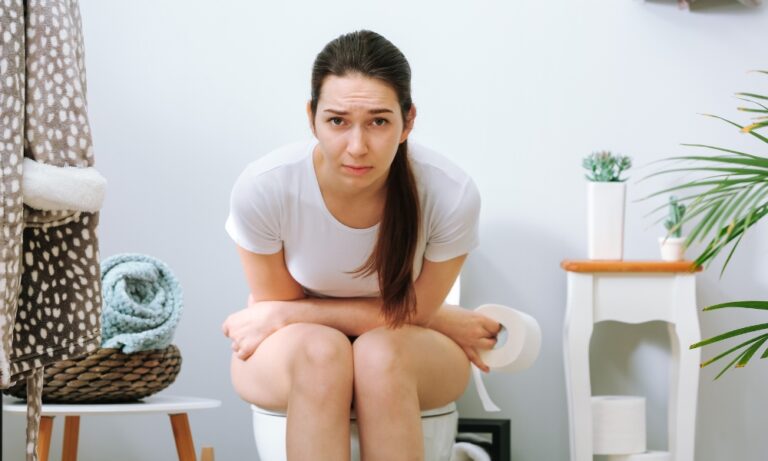 Woman sitting on the toilet with constipation
